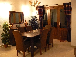 Dining area with triple doors to terrace