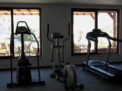 Gym with views of pool and mountains