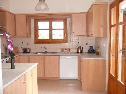 Kitchen with doors leading on to balcony