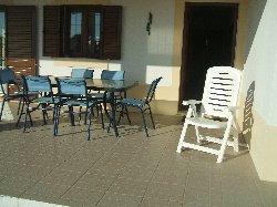 Covered outside dining area by the pool.