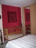 Main bedroom with wooden cot