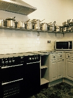 The Kitchen with ample pots and pans.