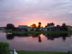SUNSET ACROSS LAKE FROM POOL AREA