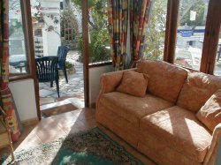 Sun room with sofa bed sleeps two.