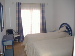Bedroom 2 with balcony overlooking pool