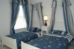 Beautiful twin bedroom with drapes