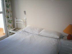 View of second bedroom with door to its
