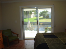 master bedroom with doors into pool
